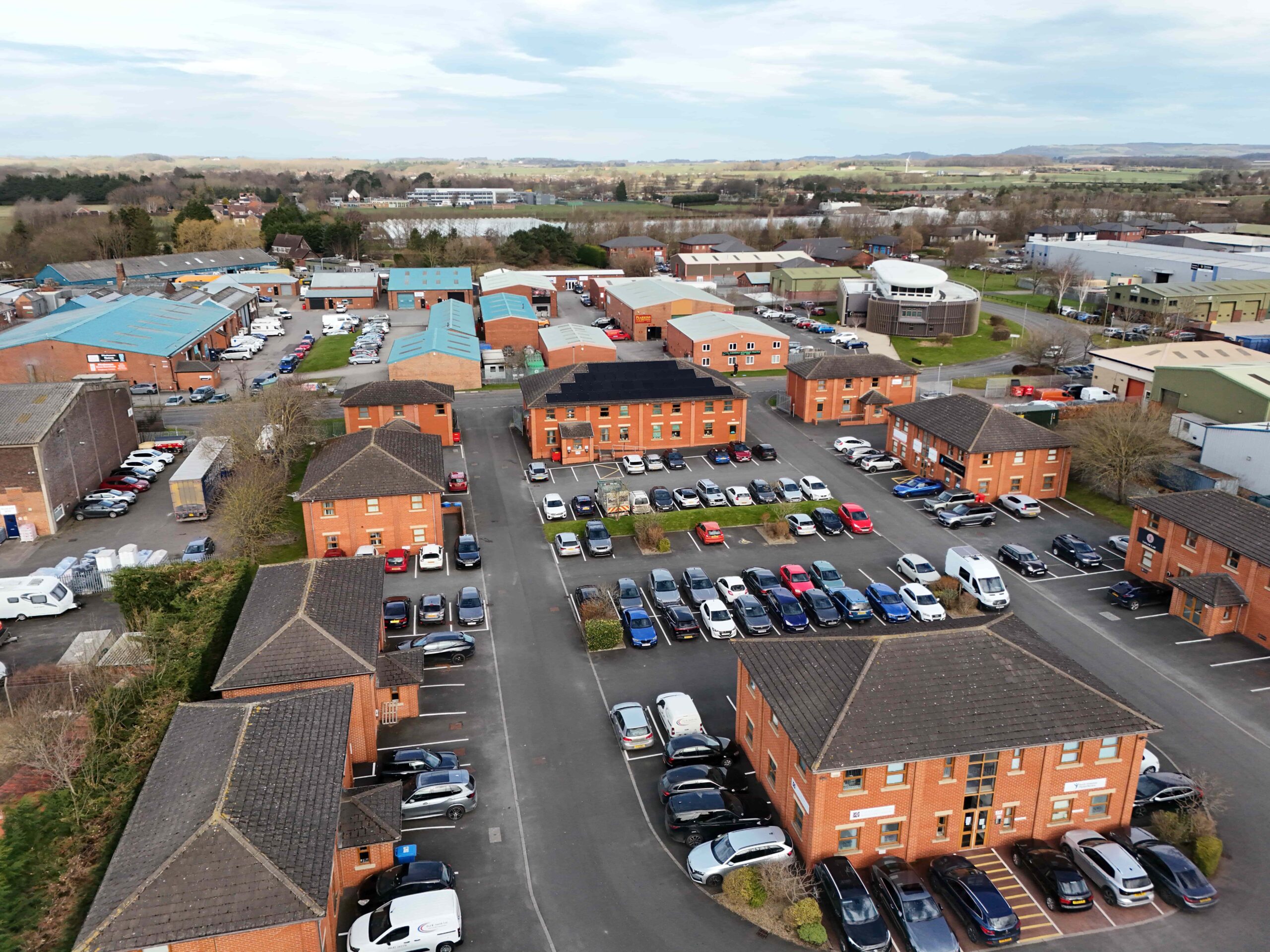 invest-strategic-Terry Dicken Business Park Aerial photograph of business park showing a combination of industrial units and office buildings with cars parked outside them